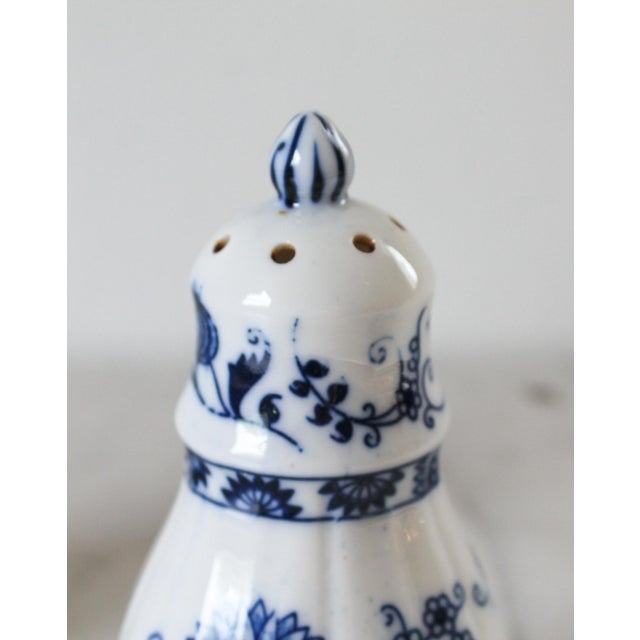 Vintage blue and white ceramic salt and pepper shakers. Makers mark on bottom. Vienna Woods Fine China. Made in Japan.
