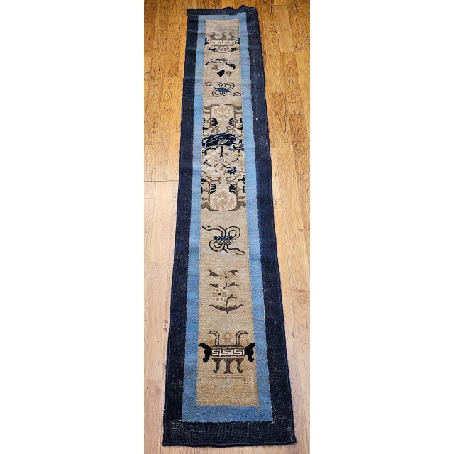 This elegant 19th century Chinese Peking hand-knotted runner woven in soft tones of ivory, navy, and baby blue. The rug...