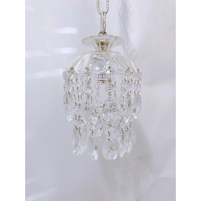 Parachute chandelier with hand cut dome, octagon chain, plain chain and 30% leaded modern almond cut crystals. It has a...