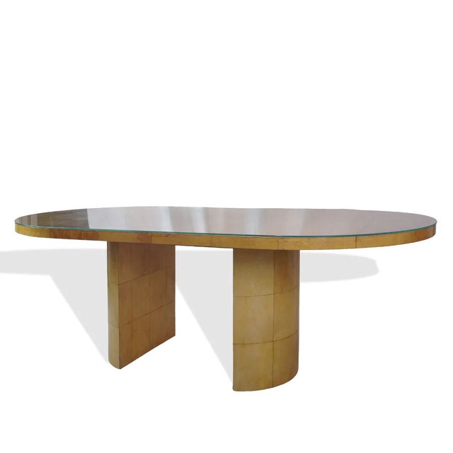 The Lacquered Goatskin Dining Table is a striking mid-century modern piece attributed to the design language of Karl...