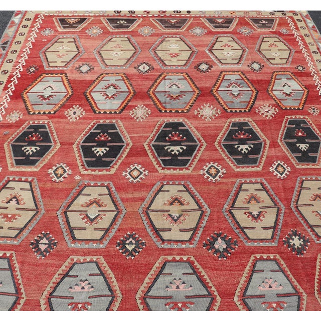 Measures: 8'8 x 12'2 This stunning antique Turkish Kilim rug features a vibrant design with intricate hexagonal motifs set...