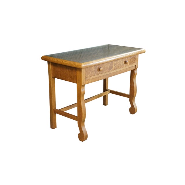 An American Empire style library table or writing desk from the Golden Oak era, circa 1890. Masterfully constructed from...