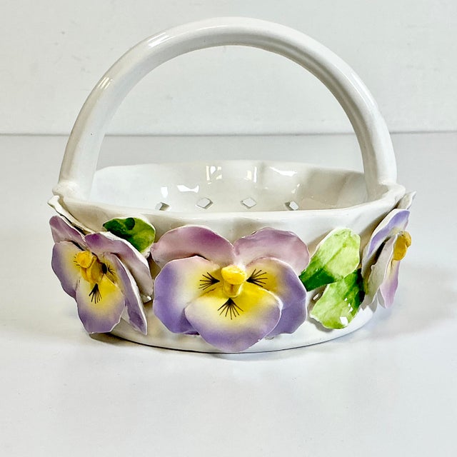 A gorgeous spring Pansy knife-cut ceramic Candy Dish Bowl. It’s in the Trompe L’Oeil style of a white wicker basket with a...
