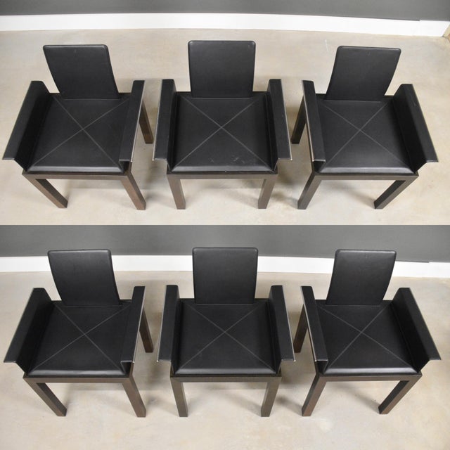 A set of six post modern black leather walnut color Haiku dining chairs made by Tresserra. Marked with the back emblem....