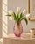 A striking cranberry-pink cased-glass vase featuring deeply cut geometric decoration that reveals the clear glass beneath....