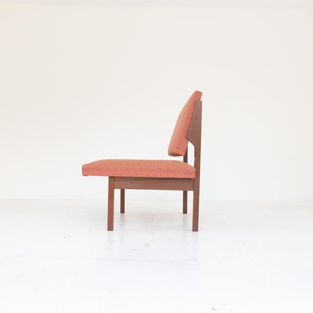 Elegant lounge bench from the 1970s, characterised by a simple solid teak wood structure with clean, geometric lines. The...