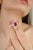This Art Deco–inspired cocktail ring is crafted in 18K white gold, featuring a vibrant 1.08 carat emerald-cut ruby at the...