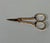 A pair of 18th-century 18k (750/1000) yellow gold sewing scissors. Decorated with chased rose motifs on a background...