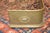 Great little curved brass fireplace fender. Purchased in the UK. Oval emblems around. 2 small flat feet in front. A good...