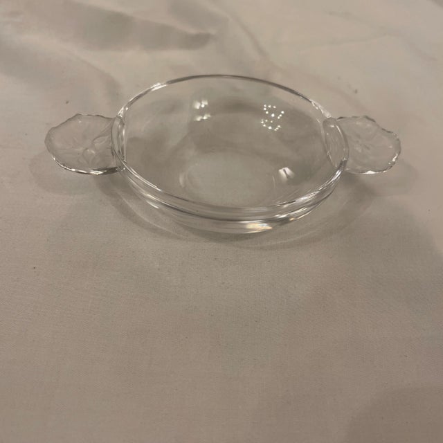 Shallow bowl made by Lalique. Two handles with frosted glass in the form of geranium leaves. Acid etch sand on bottom...