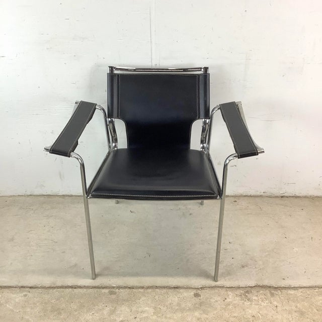Sleek and sculptural, this modern armchair pairs black leather with a polished chrome frame for a look that’s effortlessly...
