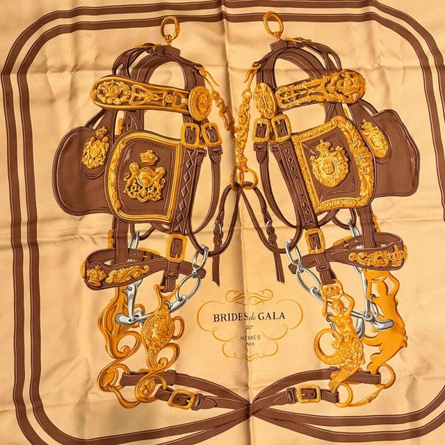 About This Piece Hermes "Brides De Gala" scarf, artfully woven from 90cm orange-brown silk, is an emblem of equestrian...