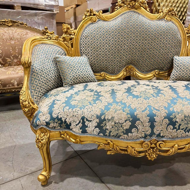 A stunning French-style settee, beautifully refinished in elegant blue damask tones with luxurious gold leaf accents. This...