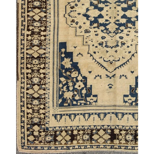Measures: 7'11 x 10'11 This vintage Oushak features classic Oushak medallion designs, with more contemporary colors. The...
