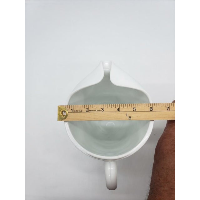 Classic vintage opaque white milk glass pitcher featuring a charming, highly detailed embossed grape and leaf pattern set...