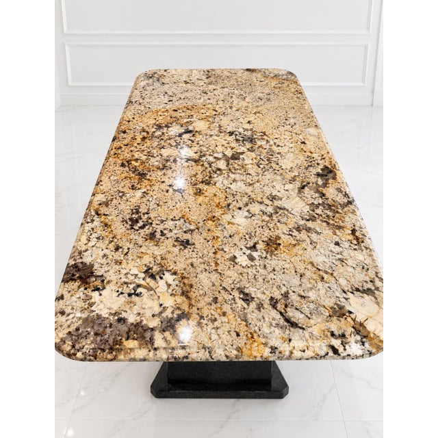 A striking custom-designed American dining table featuring genuine Brazilian Delicatus Gold granite—a substantial...