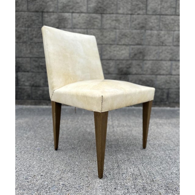 A rare single Dubar armless chair in original off white-creamy yelliw naugahyde upholstery. Solid, sturdy showing wear on...