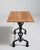 An early example of French bistro furniture featuring a decorative cast iron base designed for strength and daily use. The...