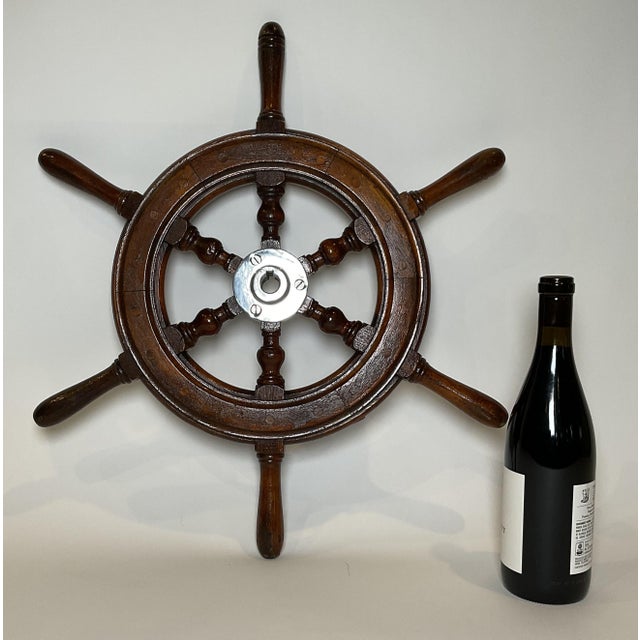 Mahogany boat wheel with a chrome plated hub and six turned spokes. Varnish finish. From a small craft. Weight: 5 lbs....