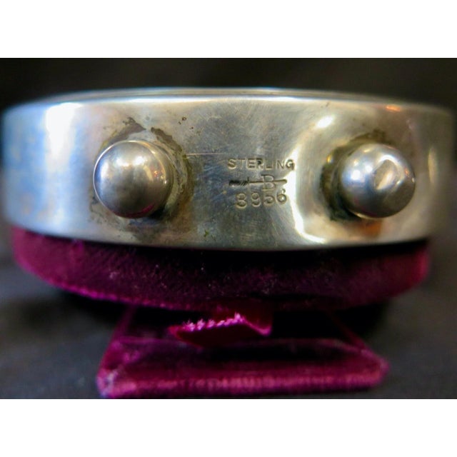 This vintage late 19th century American vanity clock is designed with a decorative motif on a sterling silver frame. The...