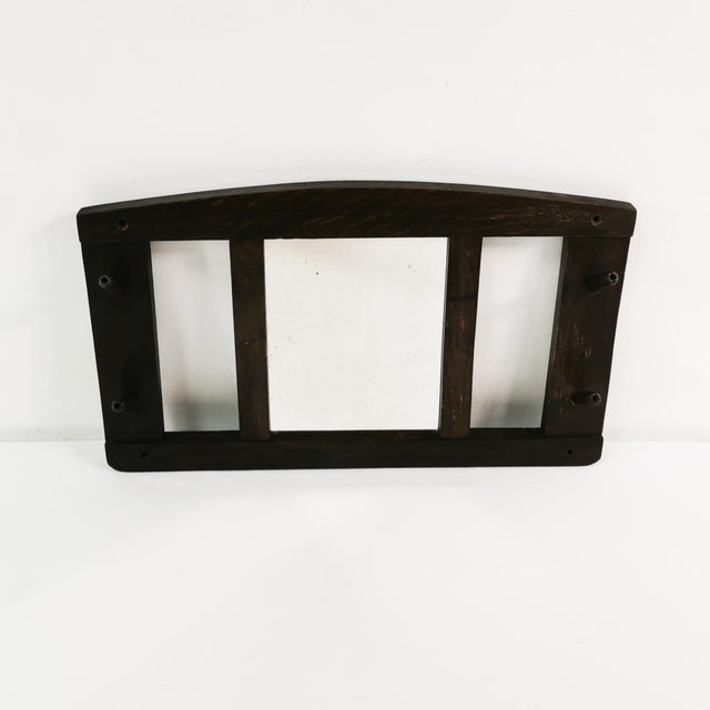 Wall hanger, Denmark, 1930s. Made of beechwood, it features a mirror in the center and two pegs on each side for hanging...