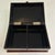 This Japanese lacquerware trinket box displays a rich mahogany-toned finish adorned with a hand-painted floral and...