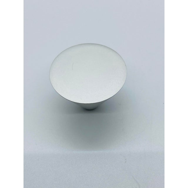 Set of 12 vintage aluminum cabinet knobs c.2000. Unique cone shape. Measurements: 1-1/8" projection & 1-3/8" diameter.