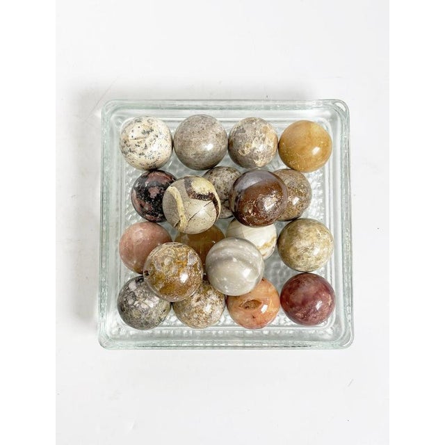 Decorative set of polished marble and natural stone spheres, France, circa 1970s. Each sphere features distinctive...
