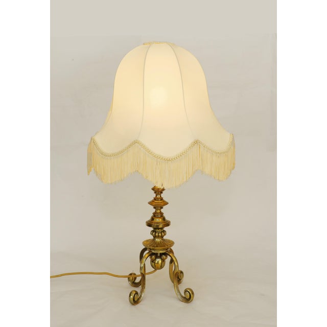 Vintage Table Lamp Floor lamp made around 1920. Brass with four curved legs and a tall column. Newly made fabric shade...