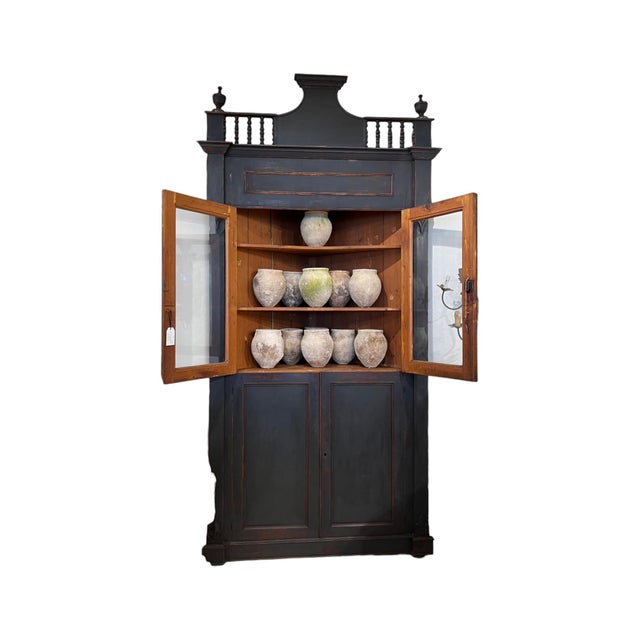 This exceptional 18th-century Italian corner cabinet features a richly ebonized finish that highlights its elegant...