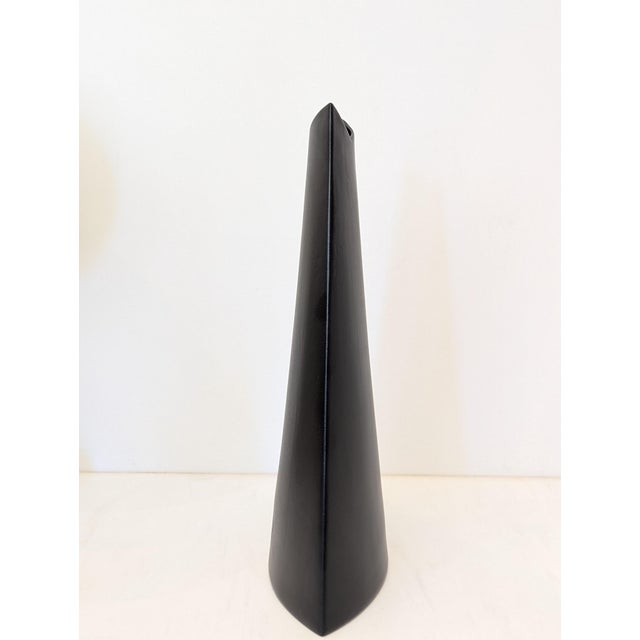 A sculptural matte black ceramic vase by Evangeline Pottery of Quebec, Canada. Tall slab form with curved front profile...