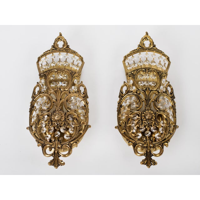 Magnificent Pair of 1960s Spanish Neoclassical Brass and Crystal Basket Wall Sconces. Masterfully crafted in Spain circa...