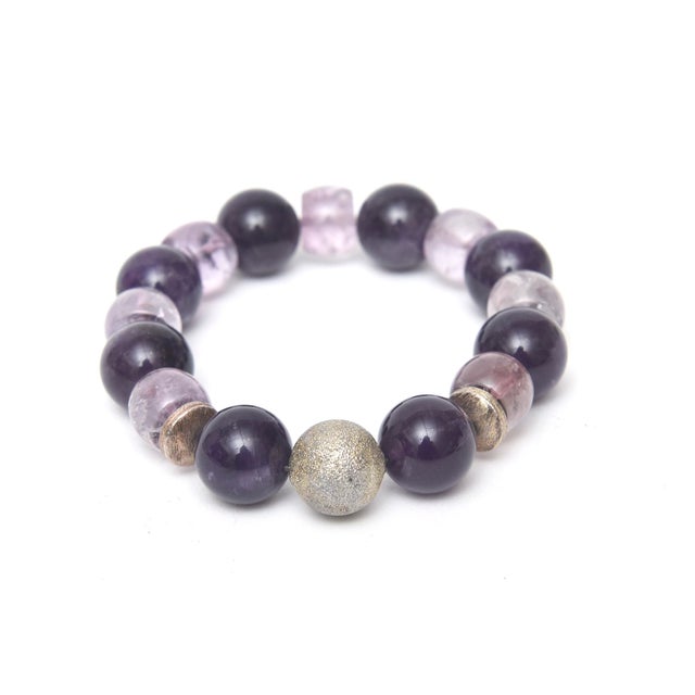 This jeweler custom made stretch bracelet has both light and dark purple stones and silver balls. It has never been worn....