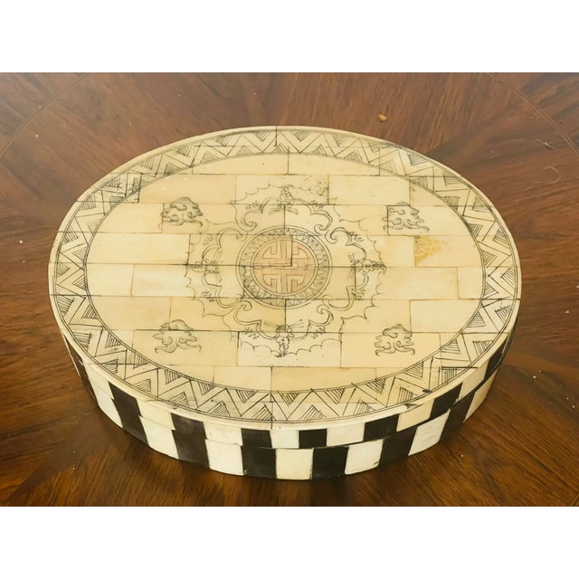 Antique Chinese bone and ebony with symbol of happiness incized on top, treasure oval box.