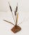 **Mid-Century Modern Metal and Rock Cattail Sculpture** This beautiful sculpture features a set of three cattails with...