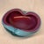 This is an Alfredo Barbini Murano turquoise blue and raspberry blown art glass bowl featuring a striking biomorphic shape...