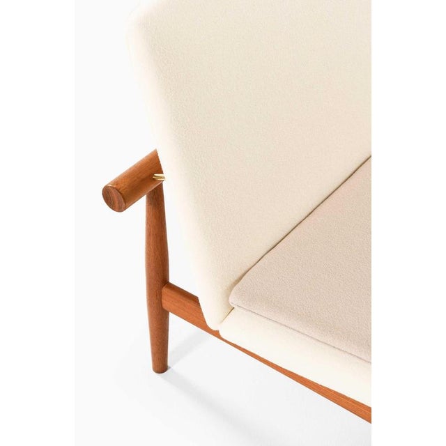 This rare pair of japan easy chairs, model fd-137, accompanied by matching footstools, was designed by the renowned danish...