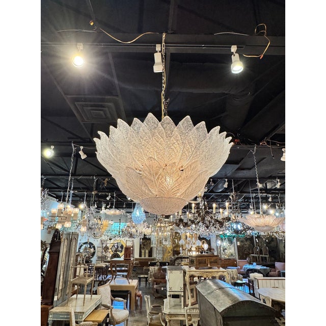 The Murano Granola Glass 2-tier Leaf Form Flush Mount Chandelier is a unique and elegant lighting fixture that adds a...