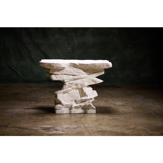 Sirmos 'Rock Quarry' Console Table in white plaster with a sculptural design inspired by natural rock formations. This...