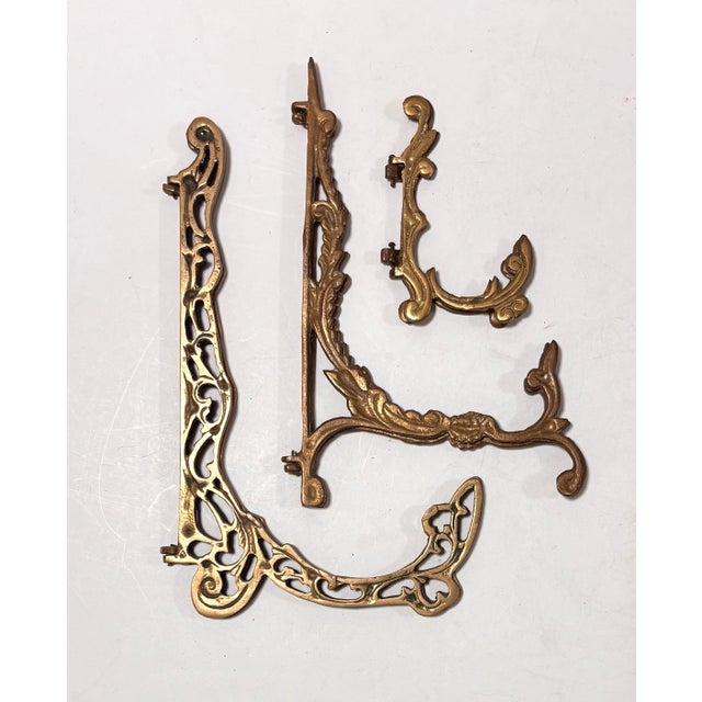 Beautiful set of decorative vintage brass easels featuring delicate cutouts and swooping intricate lines. All three are in...