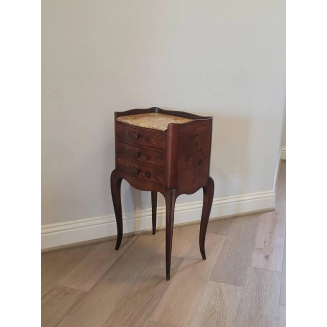 A scarce French Louis XV style nightstand with beautifully aged warm mellow patina. Born in France in the 19th century,...