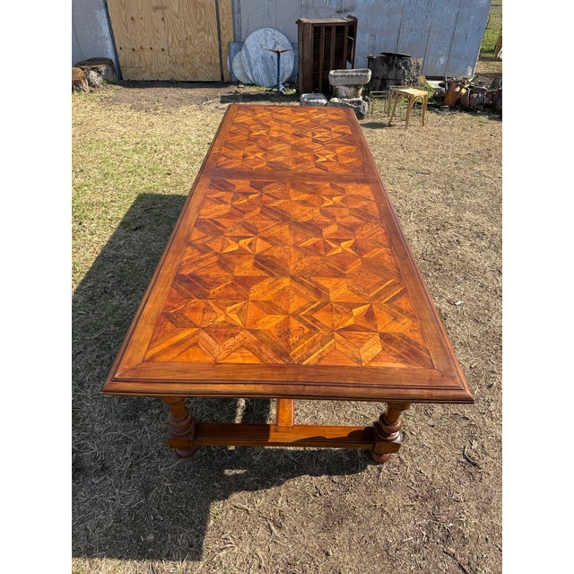 This is a beautiful 18th century French table featuring an intricate parquetry top made of richly grained hardwoods...