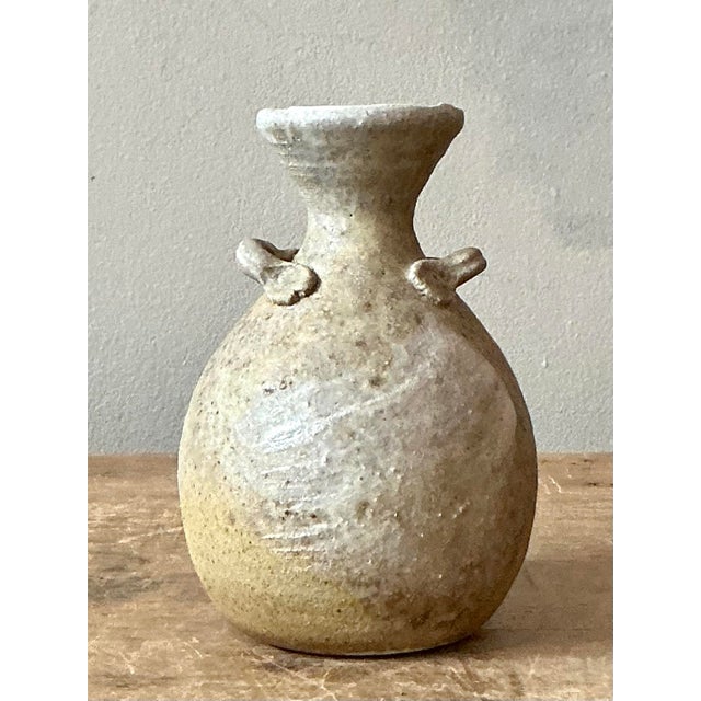 Discover the quiet beauty of handcrafted ceramics with this charming vintage studio pottery bud vase. Signed with the...