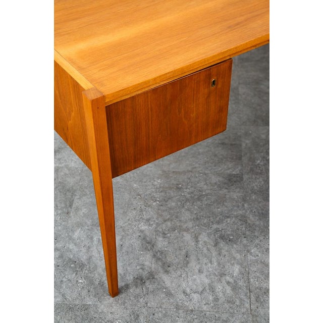 Handsome mid century modern desk by German designer / maker A.M.T.. Rich walnut wood. Sleek minimalist profile and lots of...
