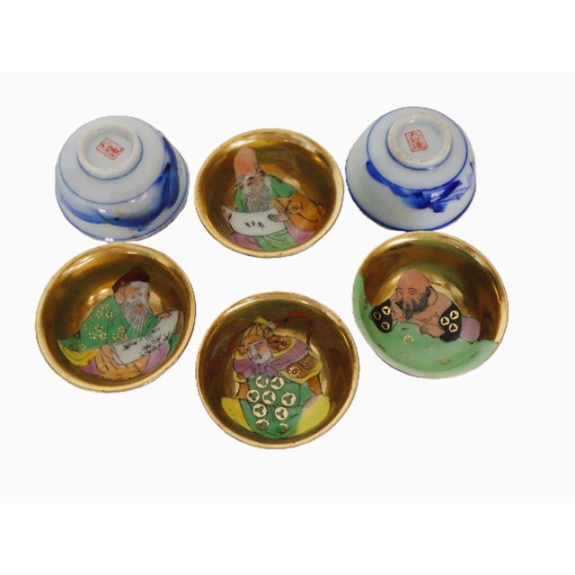 Here are six, matching per set, porcelain sake cups. I was told these were representative of six Japan gods? Hand painted...