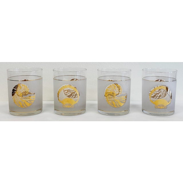 Set of four vintage Culver Ltd. lowball glasses featuring etched finish with metallic gold seashell motif. Each glass...