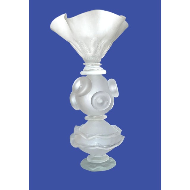 The object is a sculptural frosted glass decorative piece, like a centerpiece, likely Art Deco-inspired with strong...