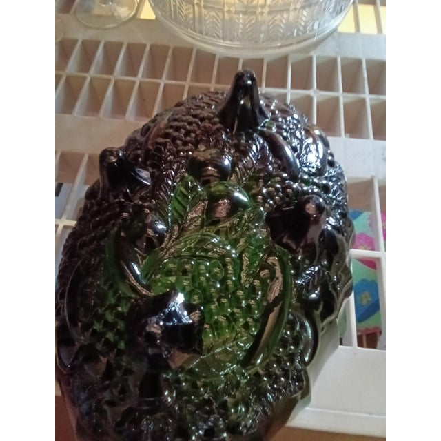Vintage green glass fruit bowl featuring an intricate embossed design. • Rich green color with a glossy finish • Embossed...