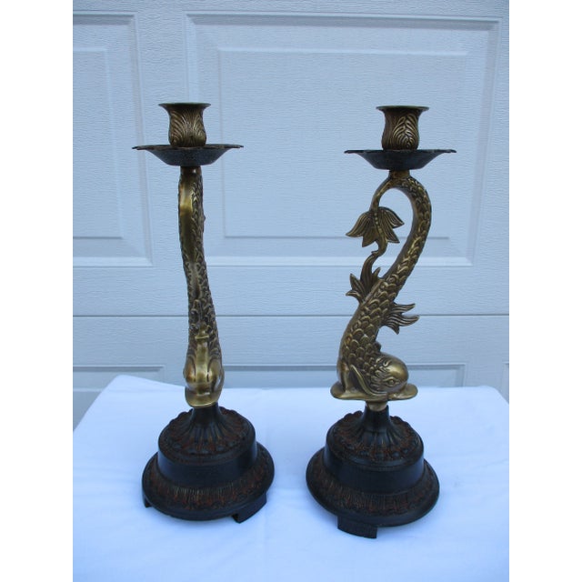 A pair of large brass koi fish, or possibly dolphin, candlestick holders on a cast metal base. Each candlestick is 16" in...