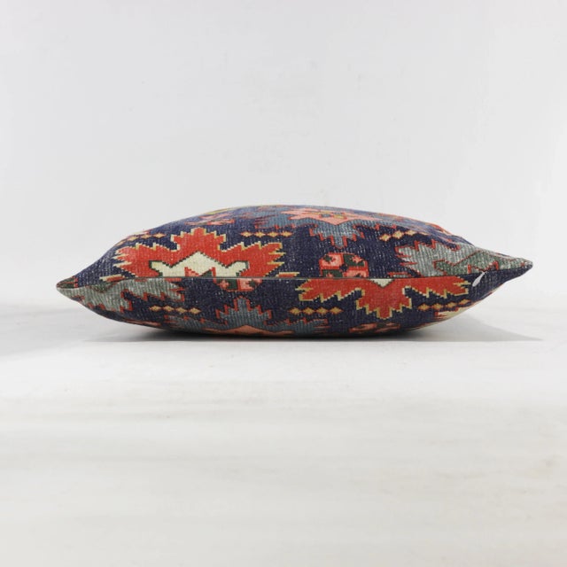 This vintage pillow showcases a bold geometric pattern inspired by Southwestern designs, with vibrant colors of green,...